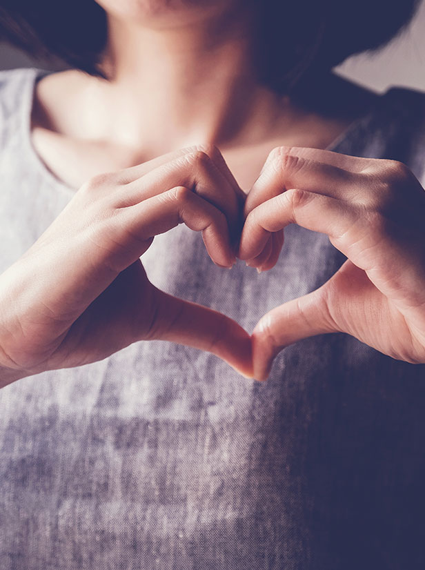 Women hands that are displaying a heart shape